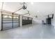Three-car garage featuring sealed floors, ample lighting, and overhead doors with decorative windows at 10055 Franklin Dr, Englewood, FL 34224