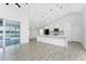 Modern kitchen with a large island, white cabinets, stainless steel appliances, and a view of the pool at 10055 Franklin Dr, Englewood, FL 34224