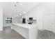 Bright kitchen with white cabinets, a large center island, and modern pendant lighting at 10055 Franklin Dr, Englewood, FL 34224