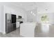 Well-lit kitchen boasting an island with quartz countertops, stainless steel appliances, and stylish pendant lighting fixtures at 10055 Franklin Dr, Englewood, FL 34224