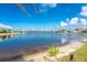 Picturesque lakefront property showcasing serene waterfront scenery under clear skies at 10055 Franklin Dr, Englewood, FL 34224