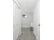 This laundry room features grey tile floors and a small window above the utility sink at 10055 Franklin Dr, Englewood, FL 34224