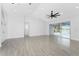 Bright living room with access to a lanai, light grey flooring, and white paint at 10055 Franklin Dr, Englewood, FL 34224