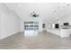 Spacious living area with tile floors, vaulted ceiling, and views of the pool and lake beyond at 10055 Franklin Dr, Englewood, FL 34224