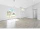 Bright open living space featuring a statement chandelier and arched windows at 10055 Franklin Dr, Englewood, FL 34224