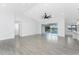 Open living space with gray flooring and large sliding glass doors that lead to a lanai area at 10055 Franklin Dr, Englewood, FL 34224