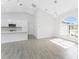 Bright open-concept living space with tile floors, pendant lighting and vaulted ceilings at 10055 Franklin Dr, Englewood, FL 34224
