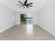 Bright living room featuring tile floors, a ceiling fan, and sliding glass doors overlooking the outdoor pool and waterfront view at 10055 Franklin Dr, Englewood, FL 34224