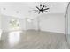 Spacious open living room with a ceiling fan and arched windows offering ample natural light at 10055 Franklin Dr, Englewood, FL 34224