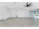 Spacious living area featuring stylish tile flooring, an open layout, and abundant natural light at 10055 Franklin Dr, Englewood, FL 34224