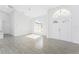 Bright living room featuring tile floors, vaulted ceilings, and arched windows at 10055 Franklin Dr, Englewood, FL 34224