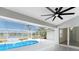 Relax in the screened-in lanai with tile floors and take in the pool and lake views at 10055 Franklin Dr, Englewood, FL 34224