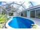 Inviting screened-in pool with a spa and seamless access to indoor living spaces at 10055 Franklin Dr, Englewood, FL 34224