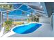 Relaxing screened-in pool area with a tranquil view and spacious patio at 10055 Franklin Dr, Englewood, FL 34224