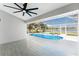 A screened-in lanai with tile floors and a beautiful view of the pool and lake at 10055 Franklin Dr, Englewood, FL 34224