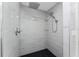 Luxury tiled shower with dual shower heads and glass shelves at 10055 Franklin Dr, Englewood, FL 34224