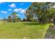 Serene backyard featuring a well-maintained lawn and mature trees for privacy at 1035 Axlewood Cir, Brandon, FL 33511
