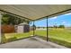 Spacious backyard with a shed, patio, and tranquil lake views on a sunny day at 1035 Axlewood Cir, Brandon, FL 33511