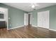 Bedroom with ceiling fan, wood floors, closet, and entrance to bathroom at 1035 Axlewood Cir, Brandon, FL 33511
