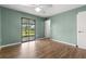 Bedroom with ceiling fan, wood floors, and sliding glass doors to outdoor patio at 1035 Axlewood Cir, Brandon, FL 33511