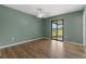 Bedroom with ceiling fan, wood floors, and sliding glass doors to outdoor patio at 1035 Axlewood Cir, Brandon, FL 33511