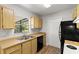 Well-lit kitchen featuring wood cabinets, black appliances, and a double stainless steel sink at 1035 Axlewood Cir, Brandon, FL 33511