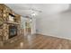 Cozy living room with wood-look flooring, stone fireplace, and open view to the kitchen at 1035 Axlewood Cir, Brandon, FL 33511