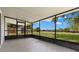 Relaxing screened porch overlooking a lush green yard and a serene lake view at 1035 Axlewood Cir, Brandon, FL 33511