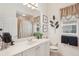 Bathroom showcasing a large mirror, white vanity, and shower with curtain at 1251 Tuscany Blvd, Venice, FL 34292
