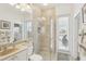 Bright bathroom showcasing a glass shower, neutral-colored tile, and a walk-out door at 1251 Tuscany Blvd, Venice, FL 34292