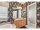 Beautiful bathroom with soaking tub, walk-in shower, and floral wallpaper at 1251 Tuscany Blvd, Venice, FL 34292