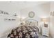 Bright bedroom featuring neutral decor, floral bedding, and decorative shelving at 1251 Tuscany Blvd, Venice, FL 34292