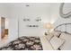 Bright bedroom featuring white walls, neutral decor, and a floral-patterned bedspread at 1251 Tuscany Blvd, Venice, FL 34292