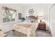 Cozy bedroom with a decorative headboard, plush bedding and a window bringing in natural light at 1251 Tuscany Blvd, Venice, FL 34292