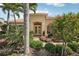 Inviting front entrance with double doors and a beautifully landscaped garden at 1251 Tuscany Blvd, Venice, FL 34292