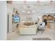 Open-concept living area with tray ceilings, fan, and seamless access to kitchen at 1251 Tuscany Blvd, Venice, FL 34292