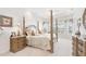 Spacious bedroom featuring a four-poster bed, tray ceilings, and lots of natural light at 1251 Tuscany Blvd, Venice, FL 34292