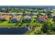A serene aerial view of a home with a screened-in pool, lush greenery, and a tranquil pond at 12520 Natureview Cir, Bradenton, FL 34212