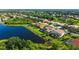 An aerial view showing a screened-in lanai of a home by the edge of a tranquil lake at 12520 Natureview Cir, Bradenton, FL 34212