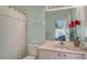 Cozy bathroom with a combination shower-tub, a single vanity, and unique light fixtures at 12520 Natureview Cir, Bradenton, FL 34212