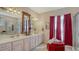 Elegant bathroom featuring dual sinks, vanity, and a large window with natural light at 12520 Natureview Cir, Bradenton, FL 34212