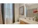 Well-lit bathroom featuring a decorative mirror and a stylish vanity area at 12520 Natureview Cir, Bradenton, FL 34212