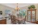 Formal dining room with a large window, chandelier, and elegant furniture at 12520 Natureview Cir, Bradenton, FL 34212