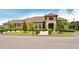 An inviting clubhouse exterior with a well-manicured lawn and beautiful landscaping at 12520 Natureview Cir, Bradenton, FL 34212