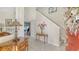 Inviting foyer features a tiled floor, decorative console table, and staircase to the upper level at 12520 Natureview Cir, Bradenton, FL 34212