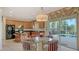 Bright kitchen with a breakfast nook, wood cabinets, and view of the screened pool area at 12520 Natureview Cir, Bradenton, FL 34212