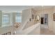 Bright upstairs landing with chandelier, natural light from windows, and neutral colored walls at 12520 Natureview Cir, Bradenton, FL 34212