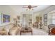 Sunlit living room featuring a comfortable sofa, ornate furnishings, and an open floor plan at 12520 Natureview Cir, Bradenton, FL 34212