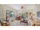 Bright and spacious living room with natural light, elegant furnishings, and a ceiling fan at 12520 Natureview Cir, Bradenton, FL 34212