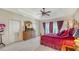 Inviting bedroom featuring tray ceilings, neutral walls, and private balcony access at 12520 Natureview Cir, Bradenton, FL 34212